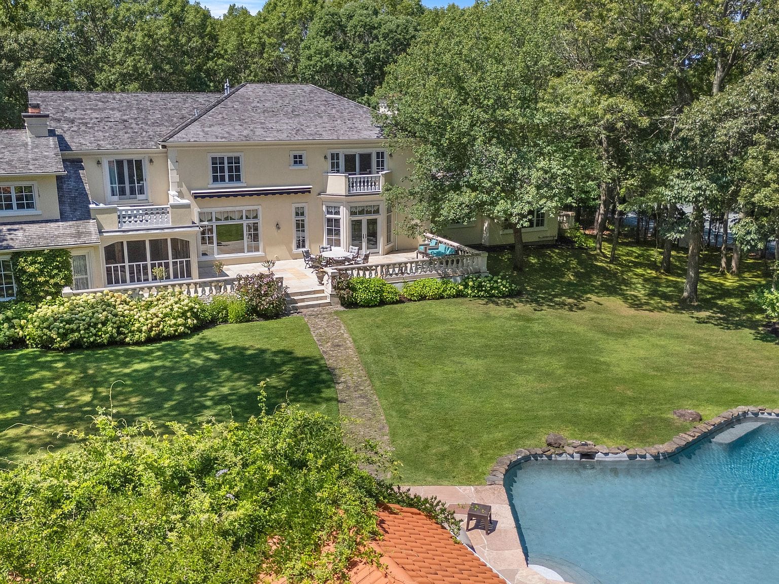 aerial, house above the lawn and the pond-shaped pool
