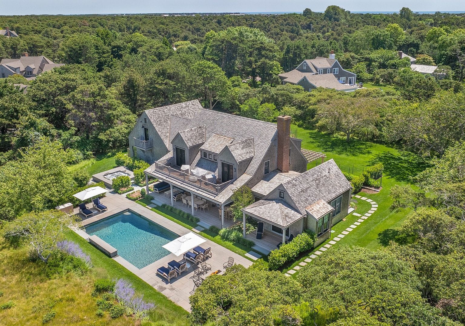 aerial of the residence, pool and terrace backing to protected open space