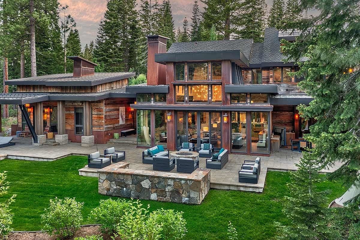 twilight rear terrace, lawn and forest backdrop