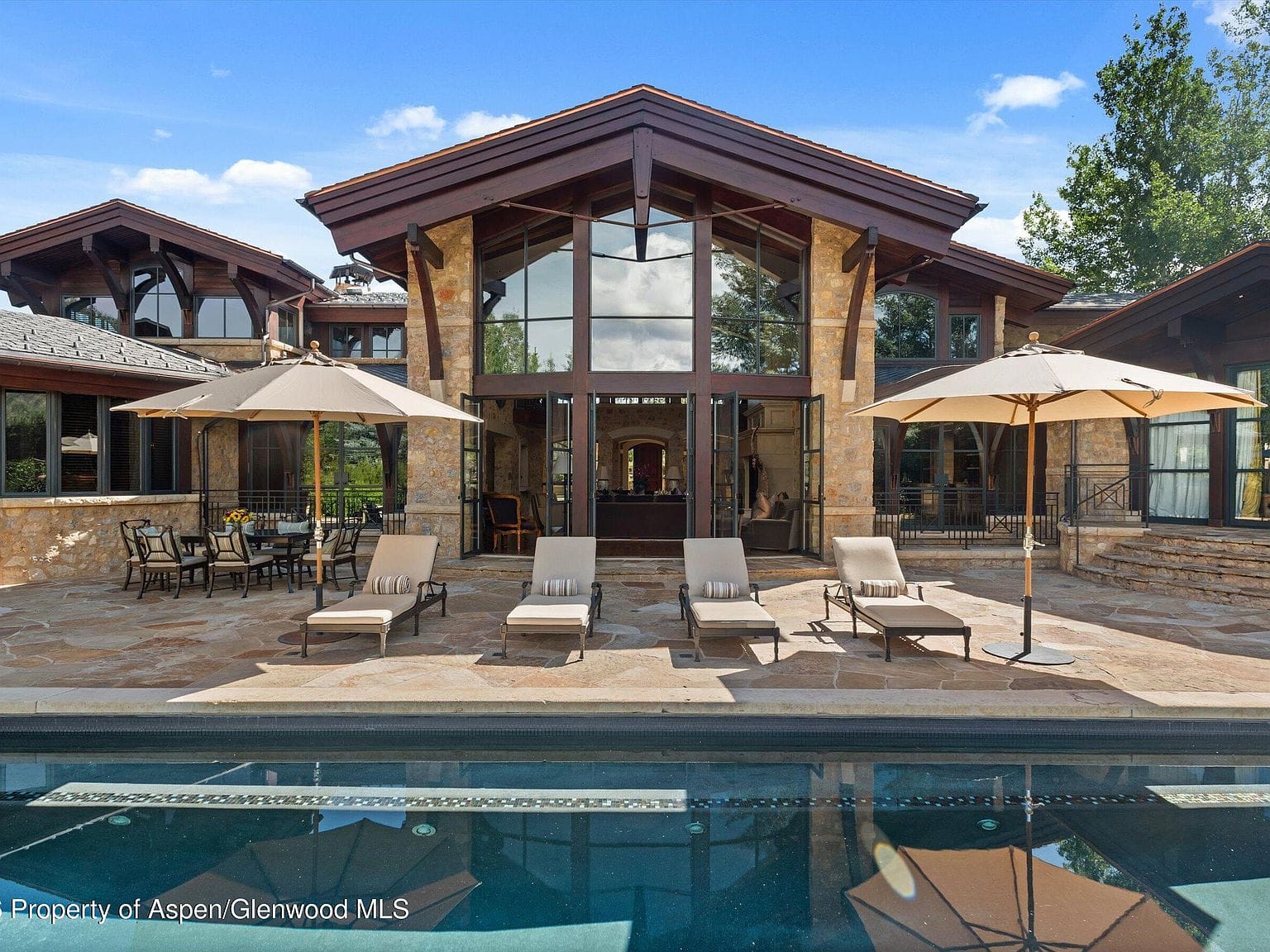 resort-style pool and glass-and-stone facade set in West Buttermilk
