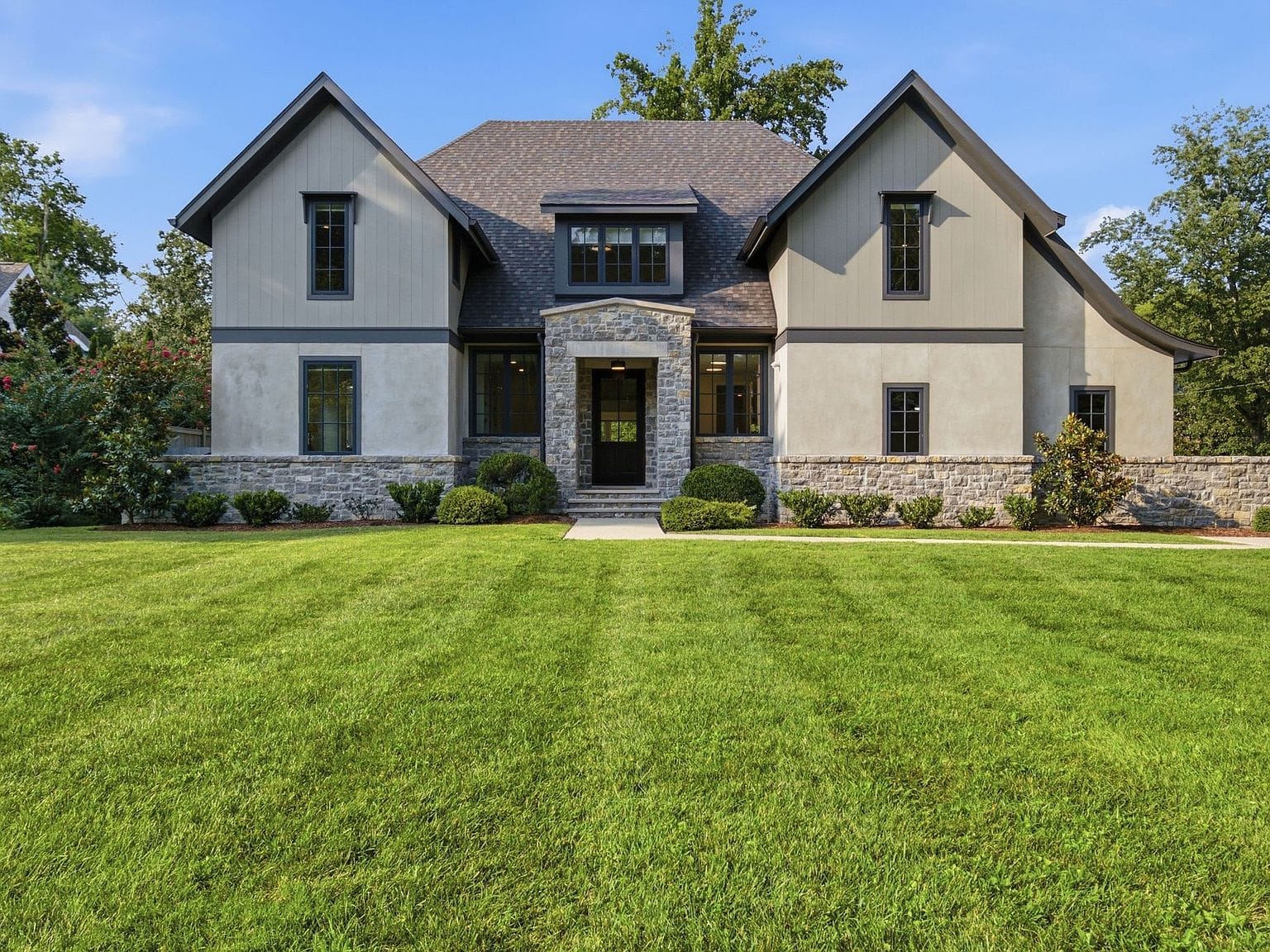 front elevation across the manicured lawn