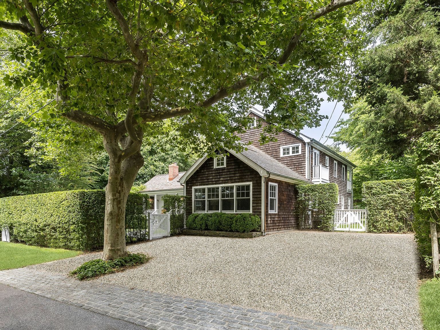 tree-lined approach to the shingled farmhouse