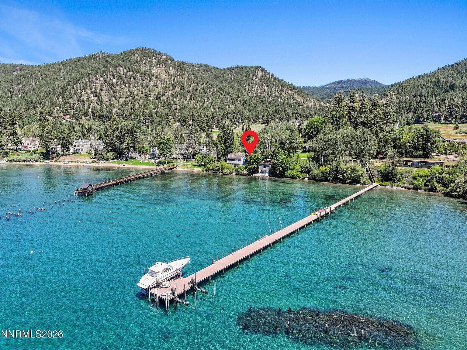 epic aerial showing the 465 ft private pier and turquoise cove