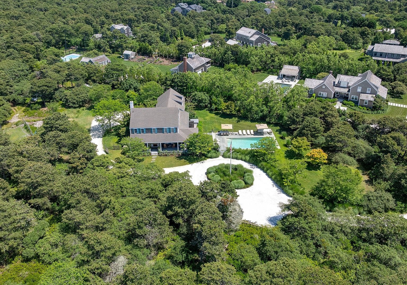 aerial over compound, pool and Surfside greenery