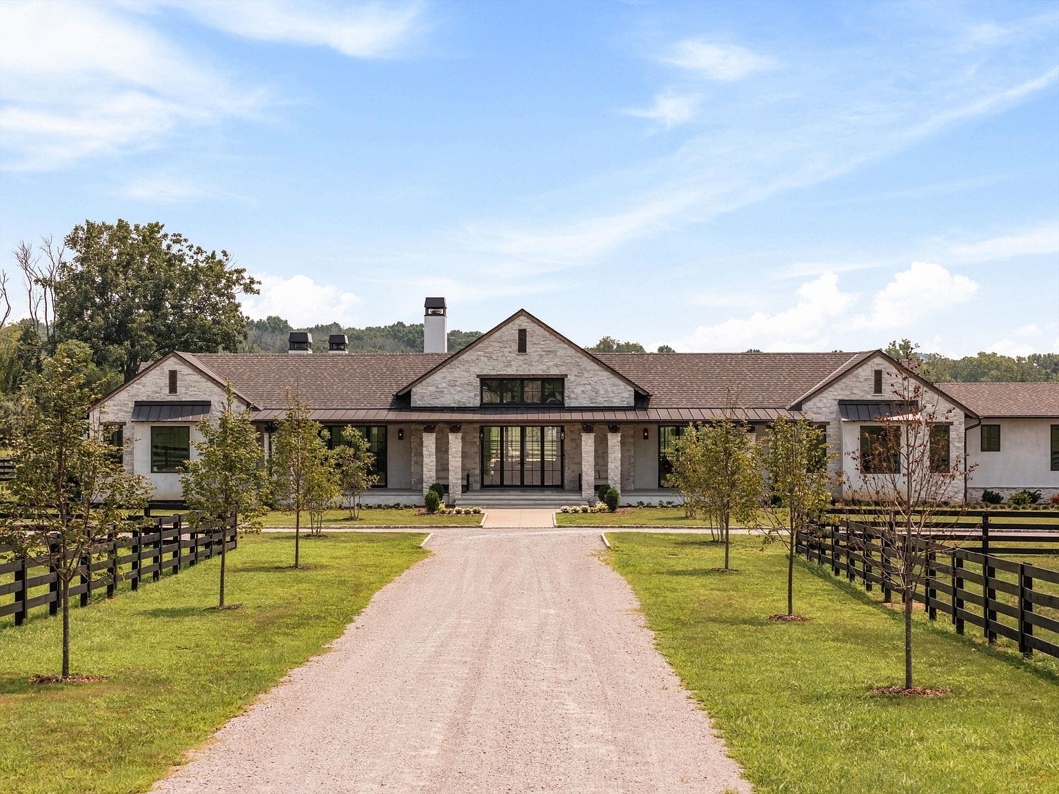 long drive to stone and stucco estate