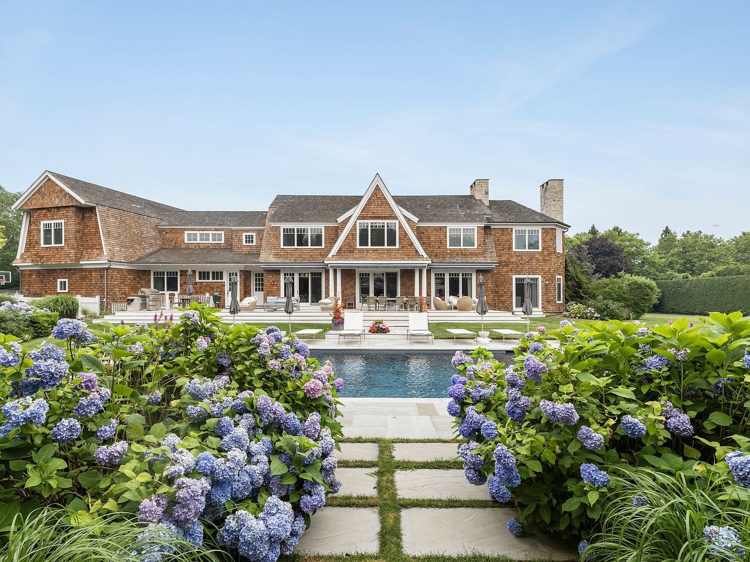 shingled Southampton estate framed by hydrangeas and garden path