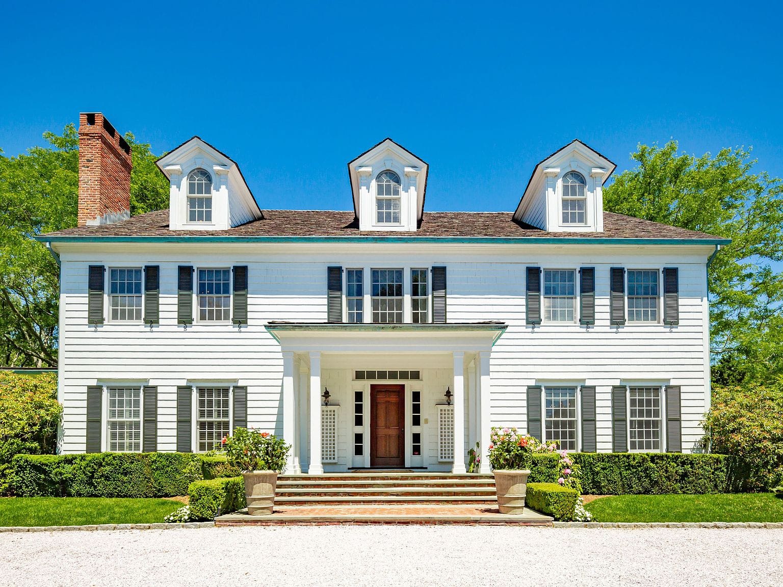 classic white shingle facade and porte-cochere