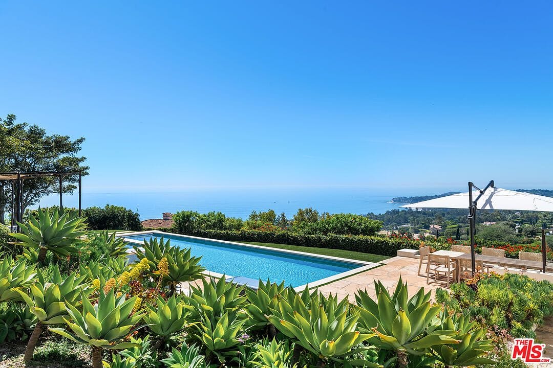 rear facade with pool and lawn, ocean backdrop