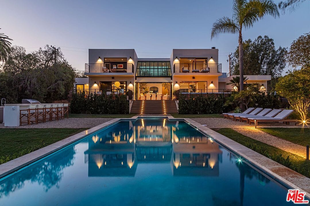 dusk facade mirrored in the 55 ft pool