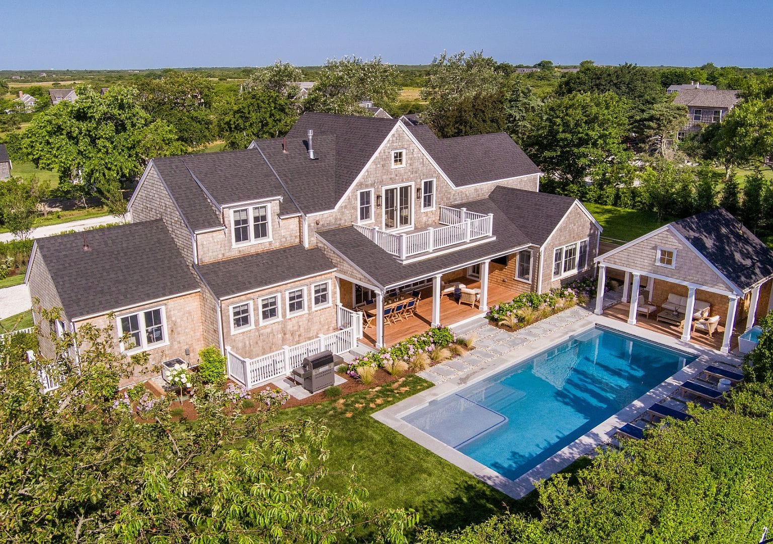 aerial of the shingle-style compound with pool and cabana
