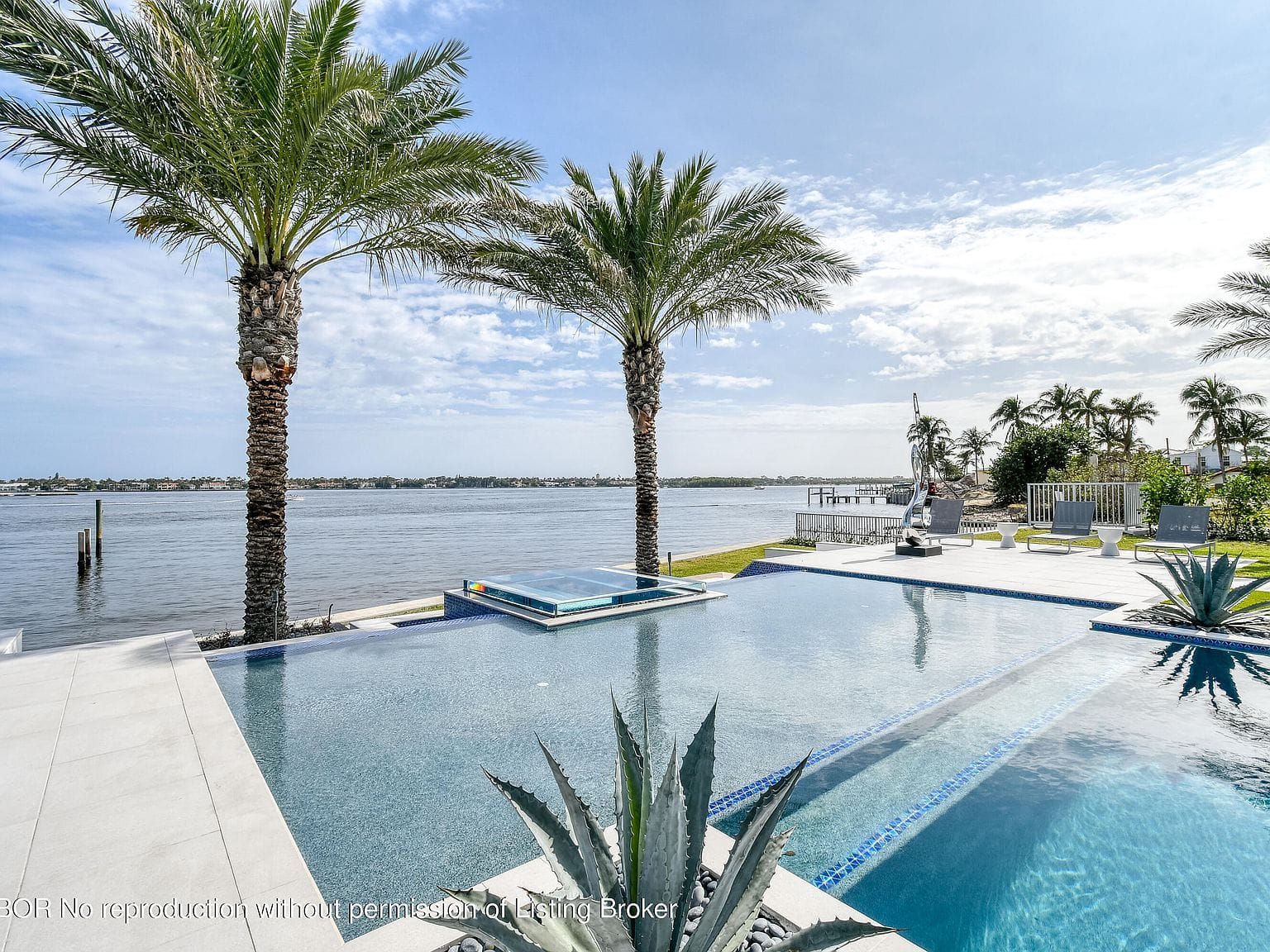 twilight rear elevation mirrored in the pool, Intracoastal beyond