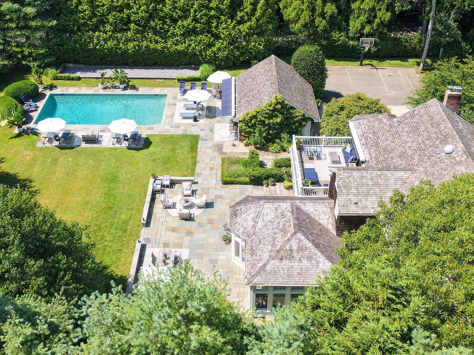 aerial over the pool and shingled home