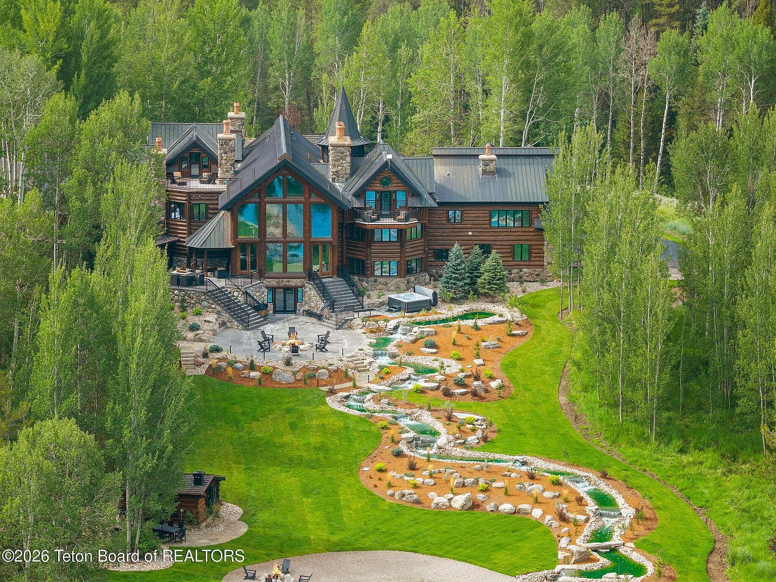 aerial, lodge above the landscaped stream and lawn