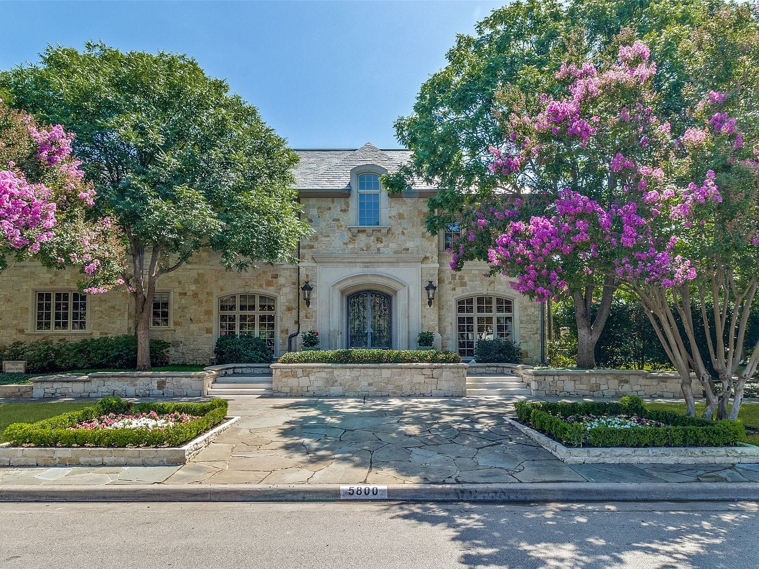 French Chateau facade framed by flowering trees