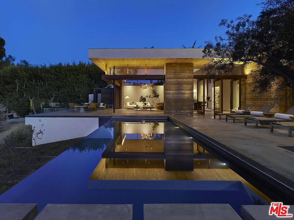 dusk exterior, infinity pool reflecting the lit house