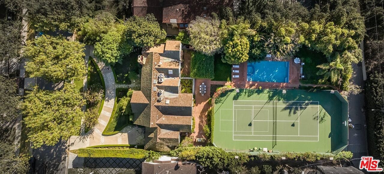 backyard overview connecting pool to the courts