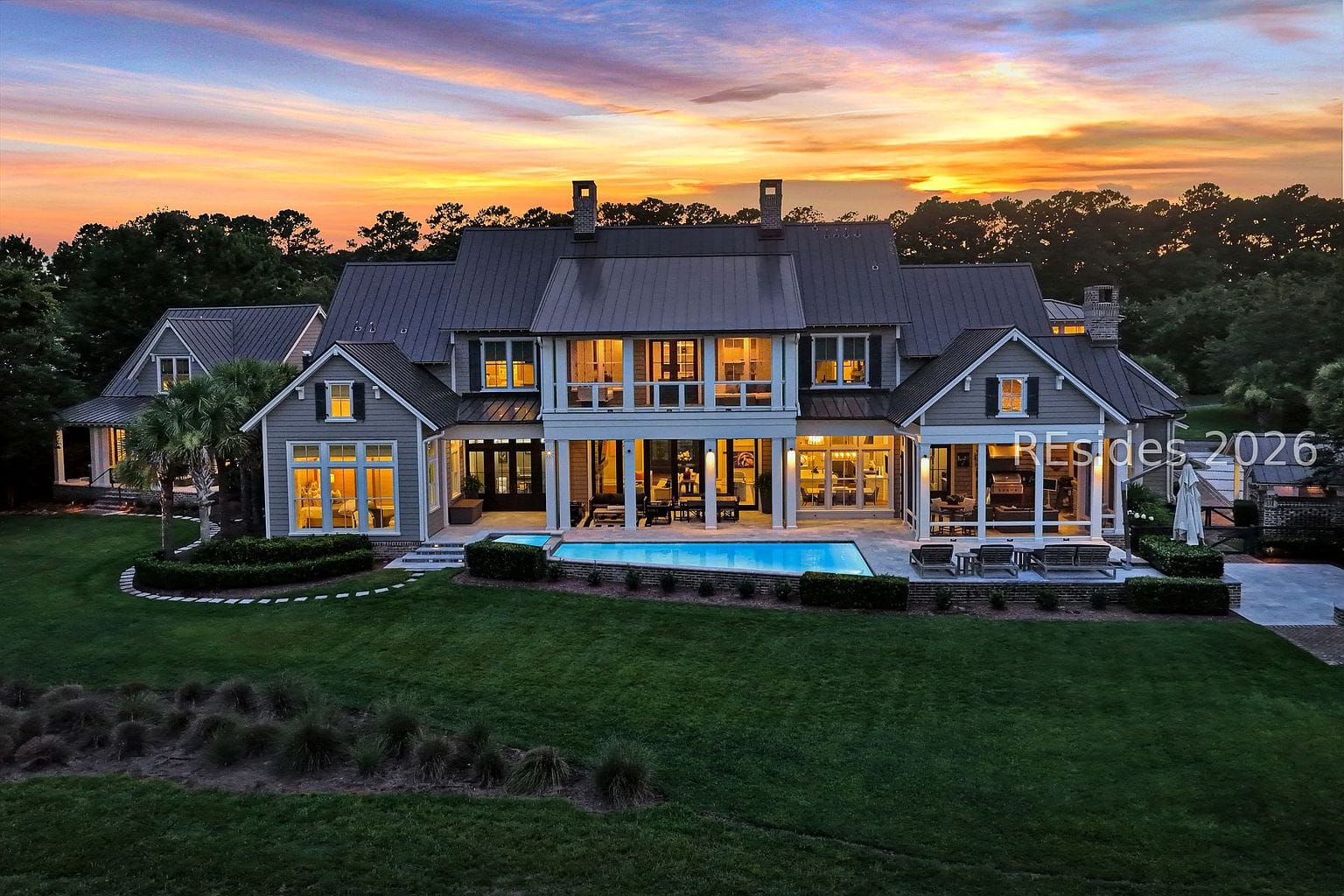 twilight rear exterior, glowing pool and spa