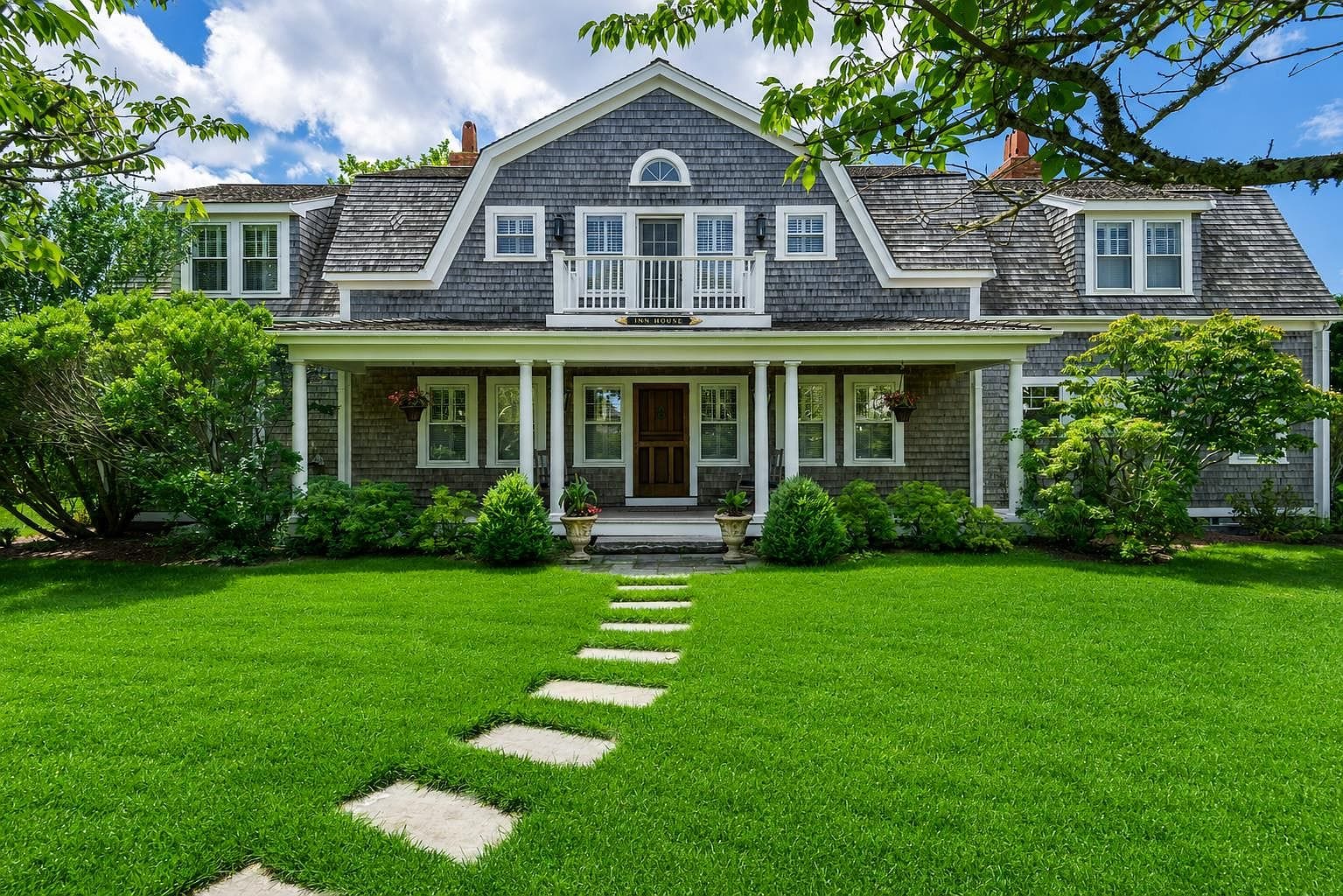 classic Nantucket facade framed by expansive lawn