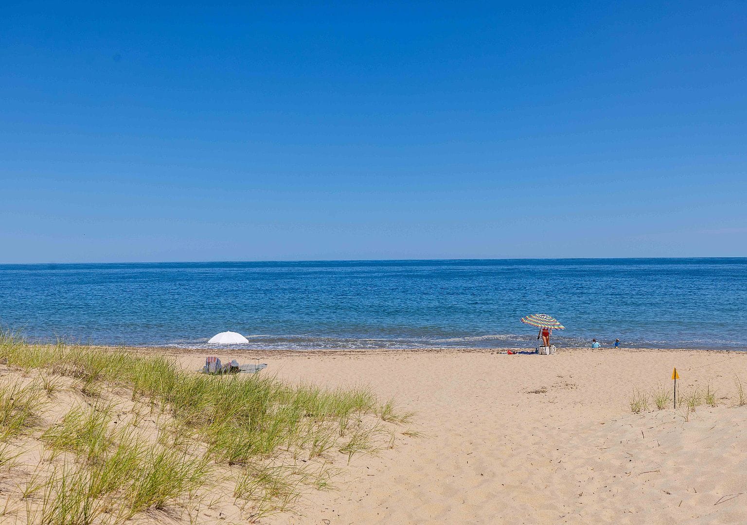 sweeping seaside lawn to the 1820 shingled farmhouse
