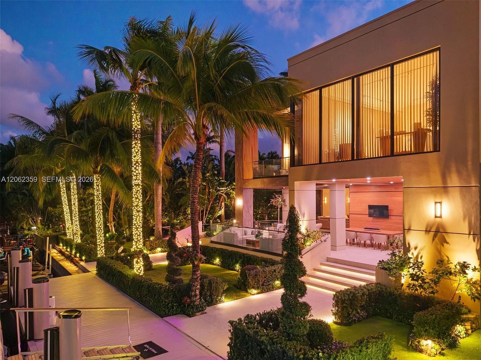 dusk glow on the sculptural facade framed by palms