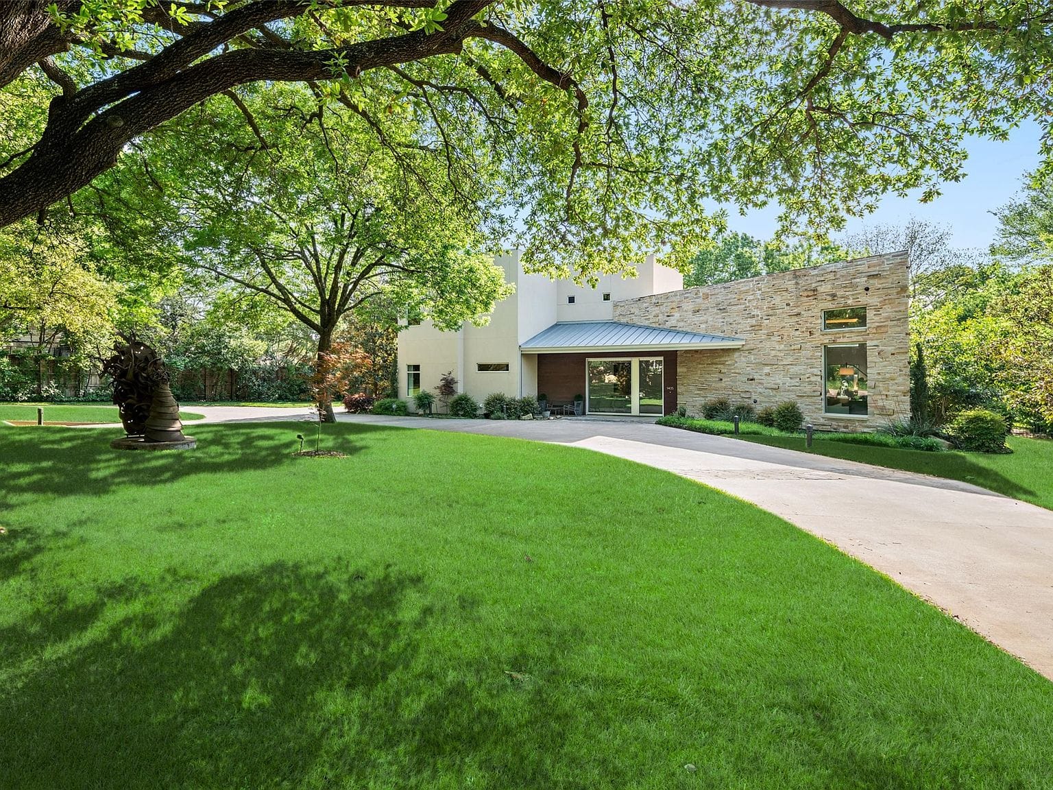 modern residence beneath mature trees